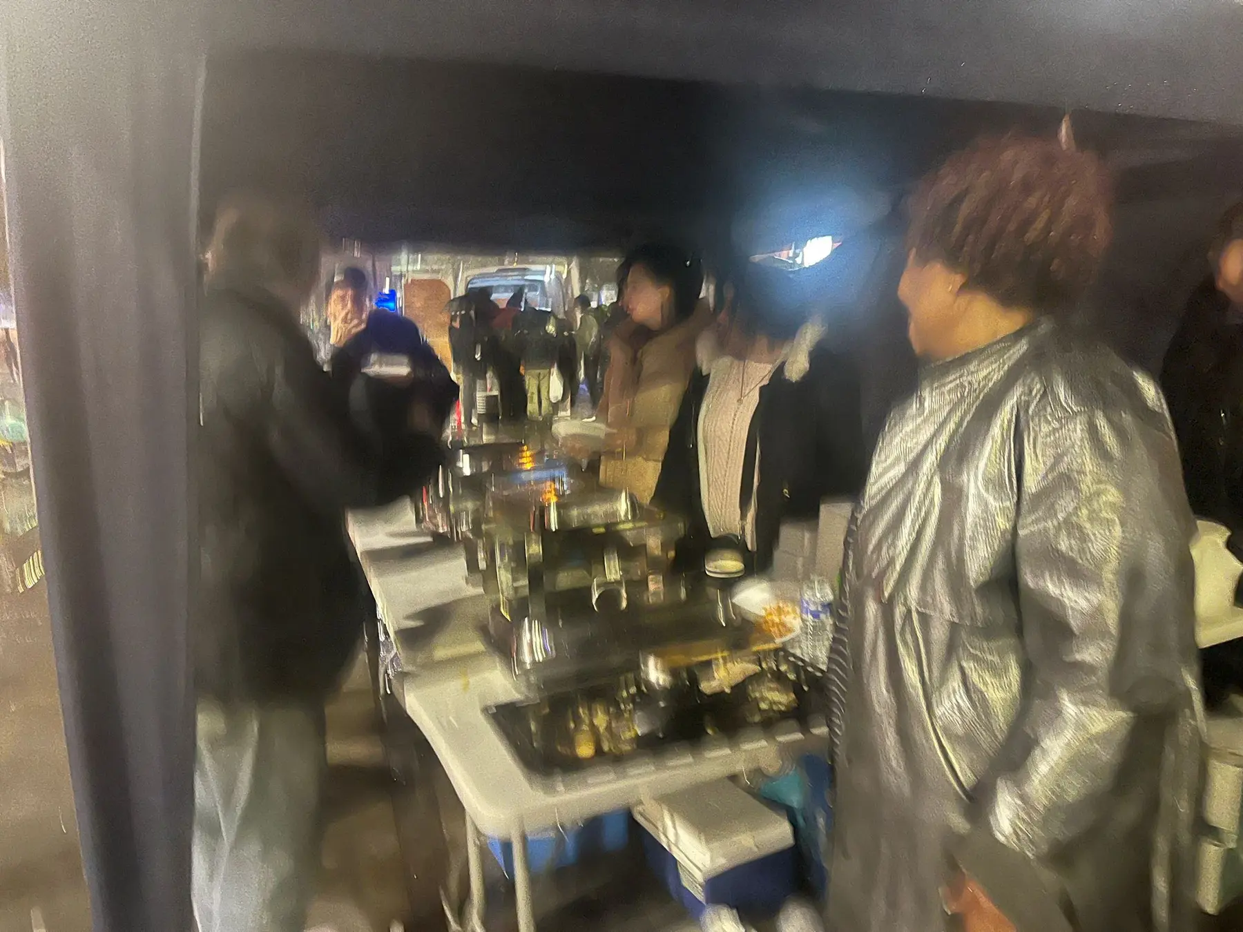 Volunteers working together around the food-serving table